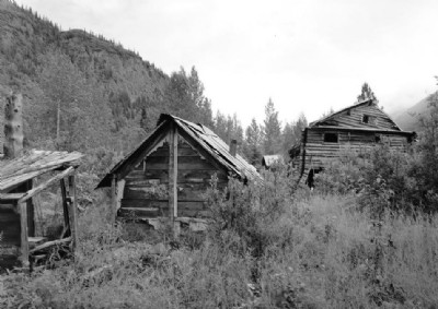 VIEW OF LOWER CAMP, SHOWING SHED, BATHHOUSE, AND BUNKHOUSE