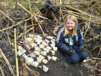 My daughter with the results of 15 minutes work - Bottles at off the Denby Pottery Tips at side of Route - May 08