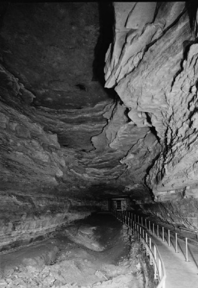 View looking towards gateway to cave entrance, under rock overhang of historic entrance