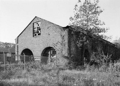 EXTERIOR VIEW SHOWING GABLED END OF STRUCTURE